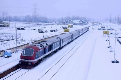 Train running across fields covered with snow in Kashmir valley